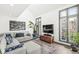 Bright living room featuring an L-shaped sofa and large windows at 9644 Highgate N Cir, Indianapolis, IN 46250