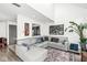 Open living area with L-shaped sofa, hardwood floors, and large artwork at 9644 Highgate N Cir, Indianapolis, IN 46250