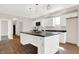 Modern kitchen with white cabinets, island, and dark countertops at 2729 Massachusetts Ave, Indianapolis, IN 46218