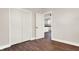Bedroom with hardwood floors, double doors, and kitchen view at 2729 Massachusetts Ave, Indianapolis, IN 46218