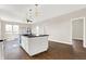 Modern kitchen with white cabinets, island, and dark countertops at 2729 Massachusetts Ave, Indianapolis, IN 46218