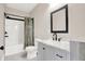 Clean bathroom with gray vanity, bathtub, and shower at 2729 Massachusetts Ave, Indianapolis, IN 46218