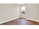 Simple bedroom with hardwood floors and a window at 2729 Massachusetts Ave, Indianapolis, IN 46218