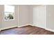 Simple bedroom with large window, new flooring, and double doors at 2729 Massachusetts Ave, Indianapolis, IN 46218