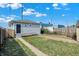 Backyard with grey house, concrete walkways, and a fenced area at 2729 Massachusetts Ave, Indianapolis, IN 46218