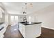 Modern kitchen with white cabinets, island, and dark countertops at 2729 Massachusetts Ave, Indianapolis, IN 46218