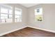 Well-lit bedroom featuring hardwood floors and two windows at 2729 Massachusetts Ave, Indianapolis, IN 46218