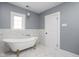 Elegant bathroom with clawfoot tub and marble tile at 3860 N Delaware St, Indianapolis, IN 46205