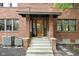 Brick home exterior with a charming covered entryway and steps leading to the front door at 3860 N Delaware St, Indianapolis, IN 46205