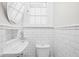 Small bathroom with white subway tiles, a pedestal sink, and toilet at 3860 N Delaware St, Indianapolis, IN 46205