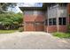 Two-car garage with wood doors and brick exterior at 3860 N Delaware St, Indianapolis, IN 46205