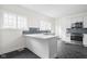 Modern white kitchen with stainless steel appliances and hexagon tile floor at 3860 N Delaware St, Indianapolis, IN 46205