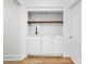 Built-in wet bar with white cabinets and wood shelving at 3860 N Delaware St, Indianapolis, IN 46205