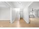 Light-filled hallway with hardwood floors and staircase leading upstairs at 3860 N Delaware St, Indianapolis, IN 46205