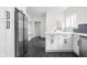 Modern white kitchen with stainless steel refrigerator and hexagon tile floor at 3860 N Delaware St, Indianapolis, IN 46205