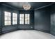 Empty dining room with dark walls, crown molding, and patterned tile floor at 3860 N Delaware St, Indianapolis, IN 46205