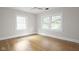 Bright bedroom with neutral walls, hardwood floors and two large windows at 3860 N Delaware St, Indianapolis, IN 46205
