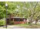 Brick house with front porch, surrounded by trees at 3860 N Delaware St, Indianapolis, IN 46205