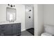 Modern bathroom with gray vanity, marble countertop, and a large walk-in shower at 3860 N Delaware St, Indianapolis, IN 46205