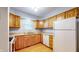 Kitchen with light wood cabinets, white appliances, and light blue walls at 709 Silver Fox Ct, Indianapolis, IN 46217