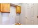 Laundry room with wood cabinets and built-in shelving at 709 Silver Fox Ct, Indianapolis, IN 46217