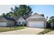 Brick ranch home with attached garage and landscaped yard at 709 Silver Fox Ct, Indianapolis, IN 46217