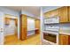 Kitchen boasts ample wood cabinets, a built-in desk, and laundry access at 709 Silver Fox Ct, Indianapolis, IN 46217