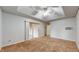Large bedroom with carpeted floors, ceiling fan, and sliding glass doors at 709 Silver Fox Ct, Indianapolis, IN 46217