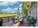 Deck with table, chairs, and umbrella overlooking a field at 5745 Paradise Dr, Martinsville, IN 46151