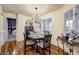Bright dining room features a round table, four chairs, and hardwood floors at 5745 Paradise Dr, Martinsville, IN 46151