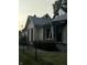 Quaint white house with black accents and a chain link fence at 1804 N Delaware St, Indianapolis, IN 46202