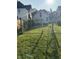 Backyard with grassy area, chain link fence, and a view of the house at 1804 N Delaware St, Indianapolis, IN 46202
