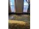 Bedroom with brown carpet and two large windows at 1804 N Delaware St, Indianapolis, IN 46202