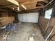 Unfinished garage with overhead door and concrete floor at 1452 E Sr 234, Greenfield, IN 46140