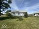Rear view of the house, showcasing a large yard at 1452 E Sr 234, Greenfield, IN 46140