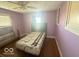 Purple bedroom with hardwood floors and a double bed at 1452 E Sr 234, Greenfield, IN 46140