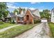 Brick home with screened porch, landscaping, and driveway at 340 Blue Ridge Rd, Indianapolis, IN 46208