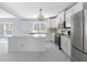 Bright kitchen featuring white cabinets, stainless steel appliances, and an island at 9259 Oak Knoll Ln, Fishers, IN 46037