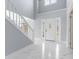 Bright entryway with white staircase and marble floors at 9259 Oak Knoll Ln, Fishers, IN 46037