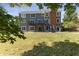 Large backyard with deck and lush green grass at 9259 Oak Knoll Ln, Fishers, IN 46037