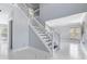 Elegant staircase with white railings and dark wood steps at 9259 Oak Knoll Ln, Fishers, IN 46037