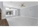 Open living room with marble-look floors and kitchen view at 9259 Oak Knoll Ln, Fishers, IN 46037