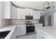 Modern kitchen with white cabinets and stainless steel appliances at 9259 Oak Knoll Ln, Fishers, IN 46037