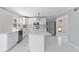 Modern white kitchen with stainless steel appliances and an island at 9259 Oak Knoll Ln, Fishers, IN 46037