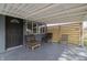 Covered patio with two chairs and a wooden privacy screen at 3730 Prospect St, Indianapolis, IN 46203