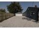 Gravel driveway and detached garage with wooden fence at 3730 Prospect St, Indianapolis, IN 46203