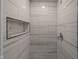 Modern shower with gray and white tiles and a built-in shelf at 3730 Prospect St, Indianapolis, IN 46203
