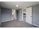 Well-lit bedroom with gray walls, carpeting, and access to other rooms at 3730 Prospect St, Indianapolis, IN 46203