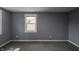 Bright bedroom with gray walls, new carpet, and a window with natural light at 3730 Prospect St, Indianapolis, IN 46203