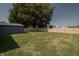 Large backyard with a wooden privacy fence and a large tree at 3730 Prospect St, Indianapolis, IN 46203